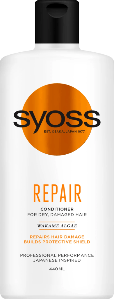 Flacon de l’après-shampoing Syoss Repair pour cheveux secs et abîmés, posé sur une étagère de salle de bain